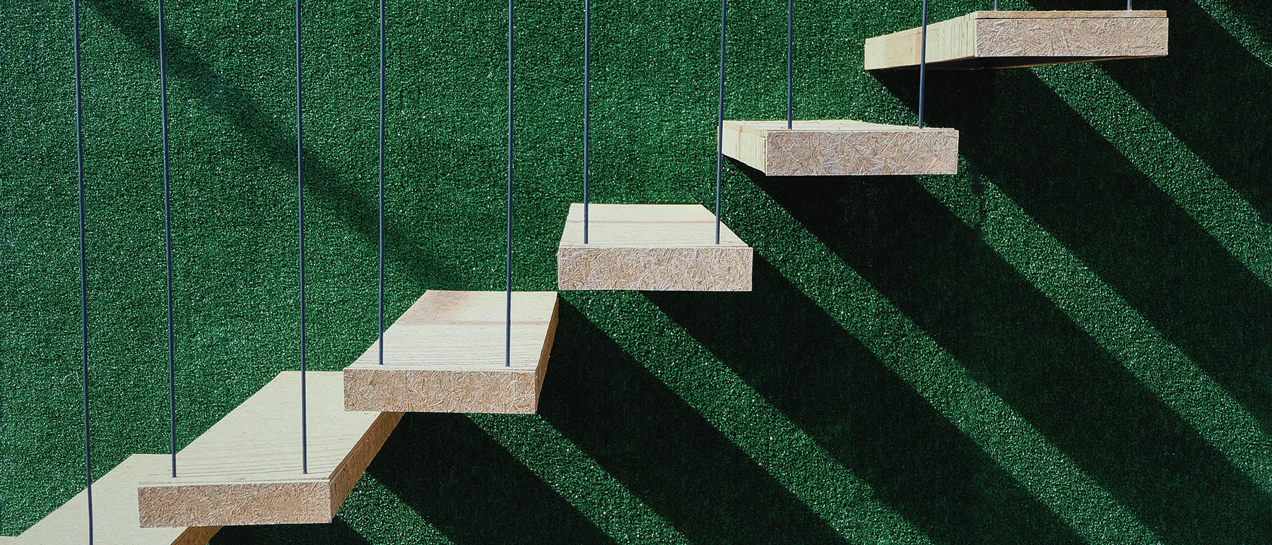 wood stairs with green background - careers at origin sustainables