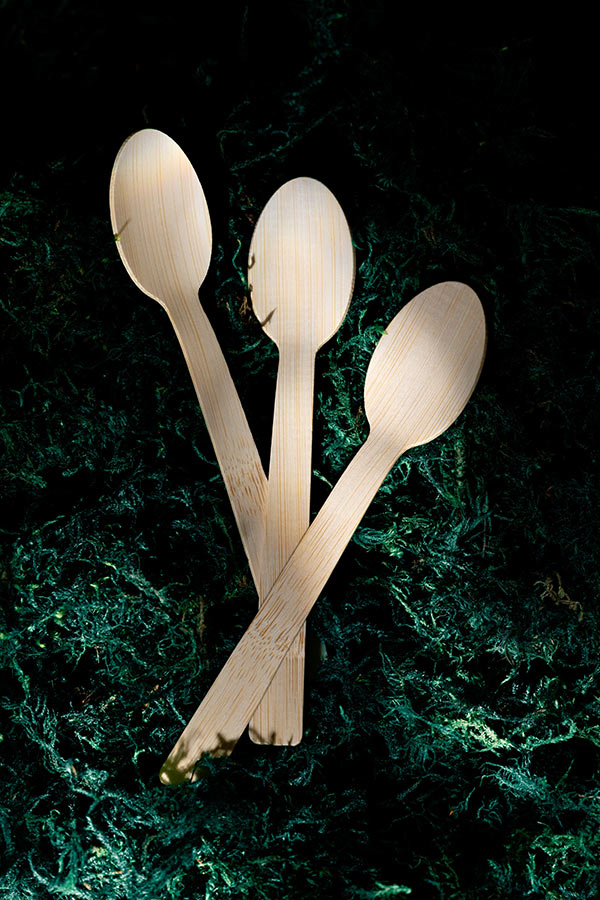 three bamboo spoons on green moss