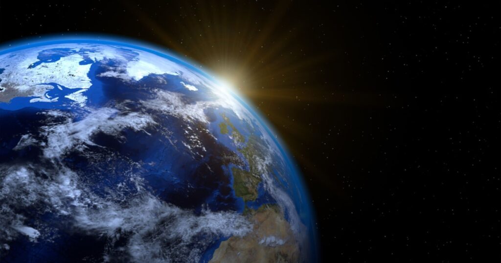 earth month: earth with sun cresting horizon