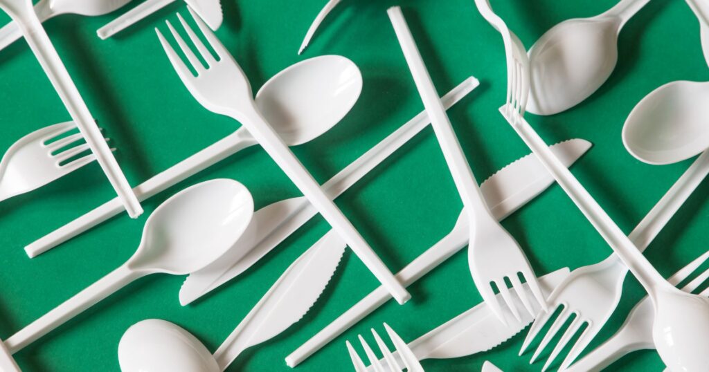 plastic cutlery on a green background, bc single-use plastic ban