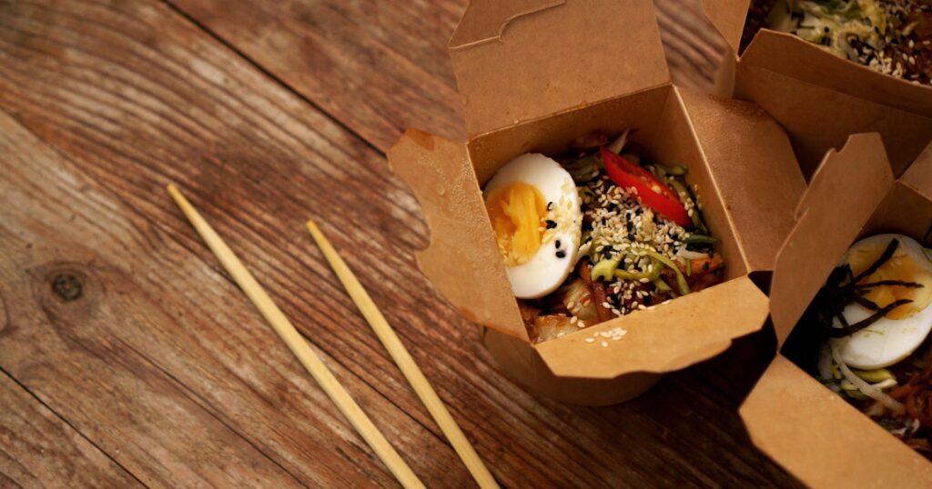 pe-lined folding takeout container with kung-pao inside