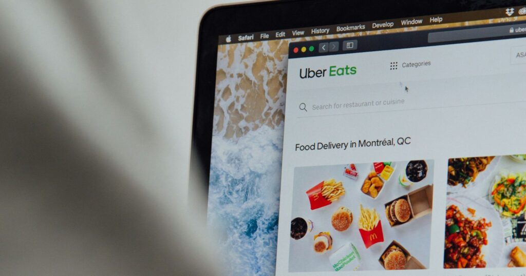 Person ordering UberEats on his Macbook - user experience takeout packaging