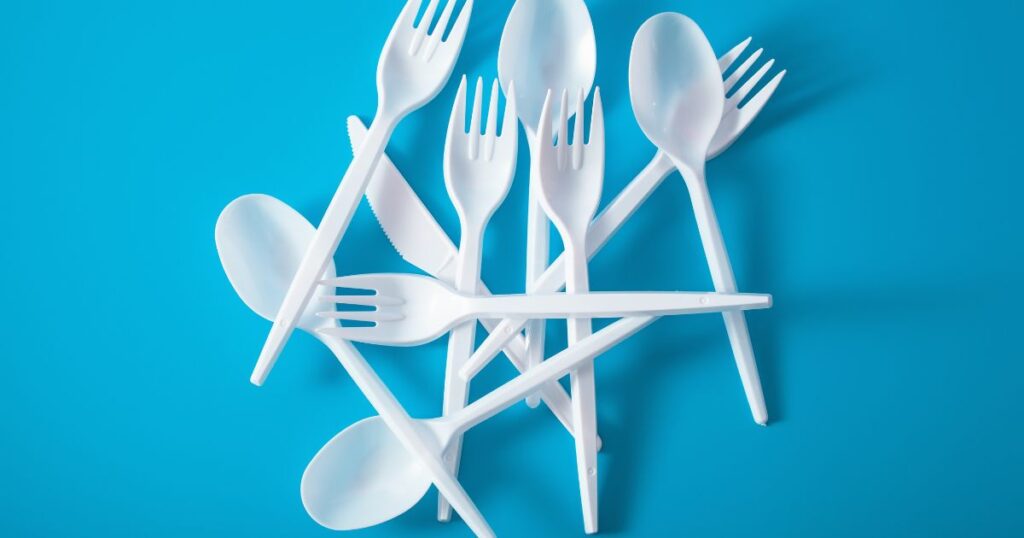 white plastic cutlery on a blue background