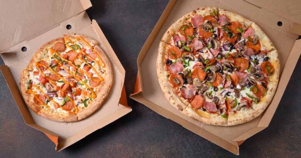 open pizza boxes on a black table, 2025 takeout packaging trends